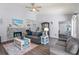 Relaxing living room with a gray sofa, stone fireplace, high ceiling, and wood-look floors at 27 Winding Creek Way, Ormond Beach, FL 32174
