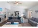 Bright living room featuring vaulted ceilings, hardwood floors, and a cozy gray sofa at 27 Winding Creek Way, Ormond Beach, FL 32174