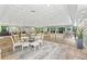 Spacious meeting room offering tables, chairs, wood floors, and views of a green and lush landscape at 27 Winding Creek Way, Ormond Beach, FL 32174