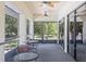 Enjoy the view from this screened patio with neutral tones and ceiling fans at 27 Winding Creek Way, Ormond Beach, FL 32174