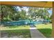 Community playground with play structures and green space framed by lush trees at 27 Winding Creek Way, Ormond Beach, FL 32174