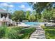 Community pool surrounded by lush landscaping, sun umbrellas, and lounge chairs for relaxing afternoons at 27 Winding Creek Way, Ormond Beach, FL 32174