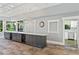 Serving area with dark cabinetry, granite countertops, pendant lights, and a pass-through to the kitchen at 27 Winding Creek Way, Ormond Beach, FL 32174