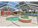 Expansive screened-in pool and spa area with multiple seating areas, perfect for entertaining and enjoying the outdoors at 27 Winding Creek Way, Ormond Beach, FL 32174