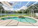 Inviting screened-in pool and spa area with lush landscaping, creating a private and relaxing outdoor oasis at 27 Winding Creek Way, Ormond Beach, FL 32174