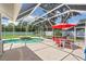 Stunning screened-in pool and spa area, complete with a red outdoor dining set, perfect for entertaining and enjoying the outdoors at 27 Winding Creek Way, Ormond Beach, FL 32174