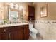 Bathroom featuring a vanity with granite countertop, decorative backsplash, and updated fixtures at 3130 Indian Trl, Eustis, FL 32726