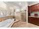 A primary bathroom suite features a soaking tub, walk-in shower, and dark wood cabinetry at 3130 Indian Trl, Eustis, FL 32726