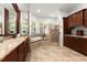 A primary bathroom suite features a soaking tub, walk-in shower and dual sink vanity with granite countertop at 3130 Indian Trl, Eustis, FL 32726