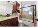 Bathroom featuring a shower over tub with glass enclosure and granite counters at 3130 Indian Trl, Eustis, FL 32726