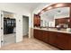 A primary bathroom suite features dual sinks, granite countertops, dark wood cabinetry and a walk-in closet at 3130 Indian Trl, Eustis, FL 32726