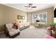 Bright bedroom featuring a ceiling fan, large windows, a desk, and a comfortable sitting area at 3130 Indian Trl, Eustis, FL 32726