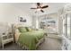 Bright bedroom features a decorative ceiling fan, a large window seat, and a quaint vanity at 3130 Indian Trl, Eustis, FL 32726