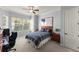 Spacious bedroom featuring a ceiling fan, large windows, and a comfortable workspace at 3130 Indian Trl, Eustis, FL 32726
