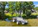 A large boat dock with boat and jet ski lifts is surrounded by lush green trees and waterways at 3130 Indian Trl, Eustis, FL 32726