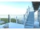Waterfront home boasts a spacious white deck, with stairs leading to a higher level at 3130 Indian Trl, Eustis, FL 32726