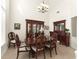 Dining room features dark wood furniture and a decorative chandelier at 3130 Indian Trl, Eustis, FL 32726