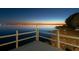 Waterfront view from the dock at dusk with a calm body of water and a distant shoreline at 3130 Indian Trl, Eustis, FL 32726