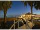Beautifully illuminated dock and boathouse with seating, perfect for enjoying sunsets and water activities at 3130 Indian Trl, Eustis, FL 32726