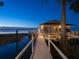 A serene waterfront home with a lighted dock, perfect for enjoying the tranquility of the lake at 3130 Indian Trl, Eustis, FL 32726