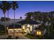 Stately waterfront home with three-car garage and a lush tropical landscape at 3130 Indian Trl, Eustis, FL 32726