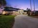 Well-manicured lawn and long driveway lead to this elegant home with a three-car garage at 3130 Indian Trl, Eustis, FL 32726