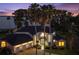 Stately waterfront home boasts lush landscaping, a large three-car garage and abundant palm trees at 3130 Indian Trl, Eustis, FL 32726