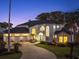 Elegant home boasts a three-car garage, long driveway, and manicured front lawn at 3130 Indian Trl, Eustis, FL 32726