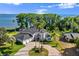 Stunning waterfront estate with lush landscaping, circular driveway, and attached three-car garage at 3130 Indian Trl, Eustis, FL 32726