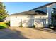 Three-car garage of this home features a wide driveway and coach lighting at 3130 Indian Trl, Eustis, FL 32726