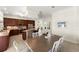 Open kitchen and dining area with dark wood cabinetry, stainless steel appliances, and granite countertops at 3130 Indian Trl, Eustis, FL 32726