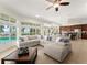 Spacious living room with a large sectional sofa, views of the pool, and an open concept layout at 3130 Indian Trl, Eustis, FL 32726