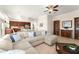 Comfortable living room with an oversized sectional sofa, a ceiling fan, and an open connection to the kitchen at 3130 Indian Trl, Eustis, FL 32726