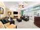 Cozy living room featuring a wet bar, comfortable seating, and access to the outdoor pool area at 3130 Indian Trl, Eustis, FL 32726