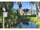 The condo boasts a tranquil pond with lush vegetation and mature trees, creating a peaceful natural setting at 3130 Indian Trl, Eustis, FL 32726