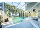 Beautiful screened-in pool with ample seating and scenic lake views at 3130 Indian Trl, Eustis, FL 32726
