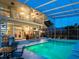 Inviting two story pool area with an outdoor dining and lounge area, spiral staircase, and screened enclosure at 3130 Indian Trl, Eustis, FL 32726