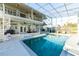 The enclosed pool area features a large pool, multiple seating areas, and a spiral staircase at 3130 Indian Trl, Eustis, FL 32726