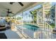 The enclosed pool area features a large pool, multiple seating areas, and lake views at 3130 Indian Trl, Eustis, FL 32726