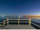 Breathtaking waterfront view at twilight with a serene lake and starry sky from a white wood deck at 3130 Indian Trl, Eustis, FL 32726