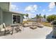 Backyard patio featuring comfortable seating, a dining area, and a grill for outdoor entertainment at 324 Plaza Blvd, Daytona Beach, FL 32118
