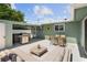 Spacious backyard patio with comfortable seating, a dining area, grill and an inviting hot tub at 324 Plaza Blvd, Daytona Beach, FL 32118