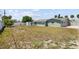 A spacious backyard with partial grass around a one-story home offers ample outdoor space at 324 Plaza Blvd, Daytona Beach, FL 32118