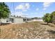Expansive backyard with a green lawn, privacy fence, and partial view of the home's exterior at 324 Plaza Blvd, Daytona Beach, FL 32118