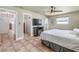 Bedroom boasts tiled floor, neutral walls, ceiling fan, and doorways to bathroom and closet at 324 Plaza Blvd, Daytona Beach, FL 32118