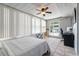 Inviting bedroom with a ceiling fan, large windows, and a sliding door to the outside at 324 Plaza Blvd, Daytona Beach, FL 32118