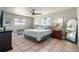 Comfortable bedroom with ceiling fan, neutral colors, windows, and tiled floor at 324 Plaza Blvd, Daytona Beach, FL 32118