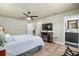 Spacious bedroom includes a TV, ceiling fan, and doorways to bathroom and hallways at 324 Plaza Blvd, Daytona Beach, FL 32118