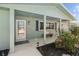 Inviting front porch with stylish seating, beautiful hibiscus flowers, and an updated entryway at 324 Plaza Blvd, Daytona Beach, FL 32118