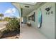 Welcoming covered front porch with a cute bench, beautiful flowers, and a surfboard decoration at 324 Plaza Blvd, Daytona Beach, FL 32118